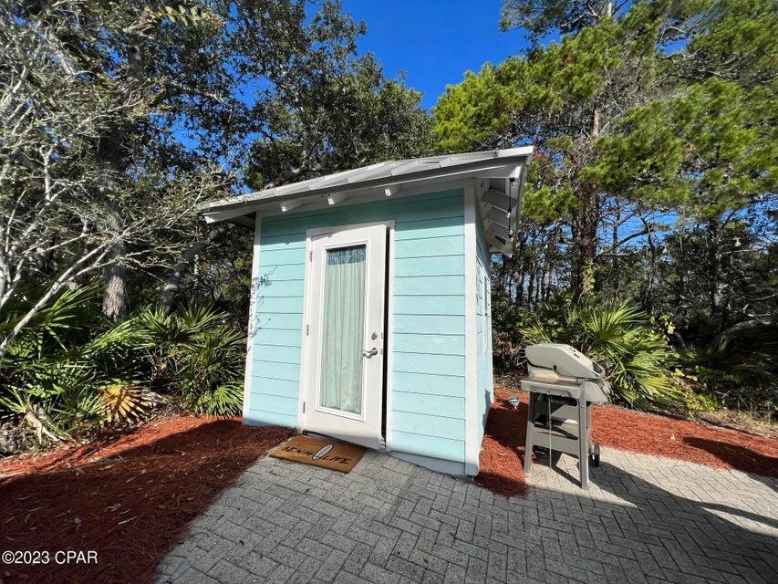 114 Parkshore Drive Panama City Beach, FL 32413 - Photo 47 of 86 a view of backyard with a barn and a cactus plant