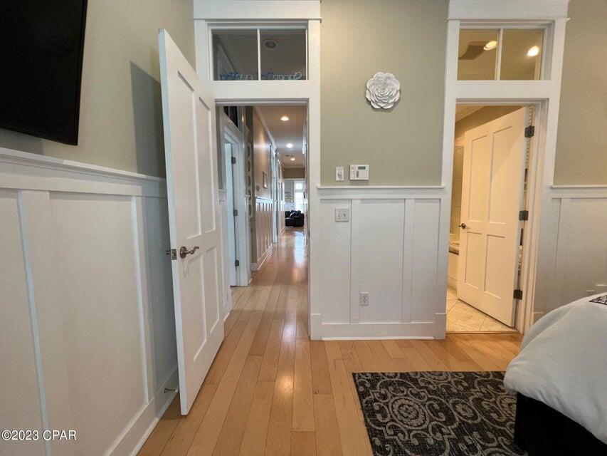 114 Parkshore Drive Panama City Beach, FL 32413 - Photo 54 of 86 a view of a hallway with wooden floor and living room