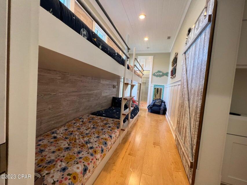 114 Parkshore Drive Panama City Beach, FL 32413 - Photo 58 of 86 a view of a hallway with wooden floor and staircase