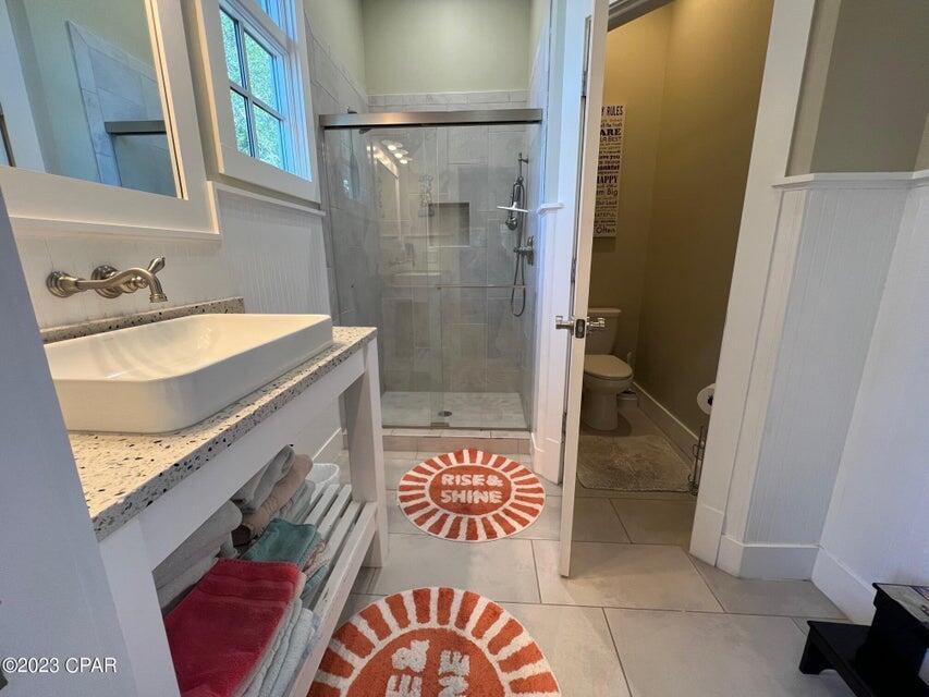 114 Parkshore Drive Panama City Beach, FL 32413 - Photo 62 of 86 a bathroom with a granite countertop sink and a shower