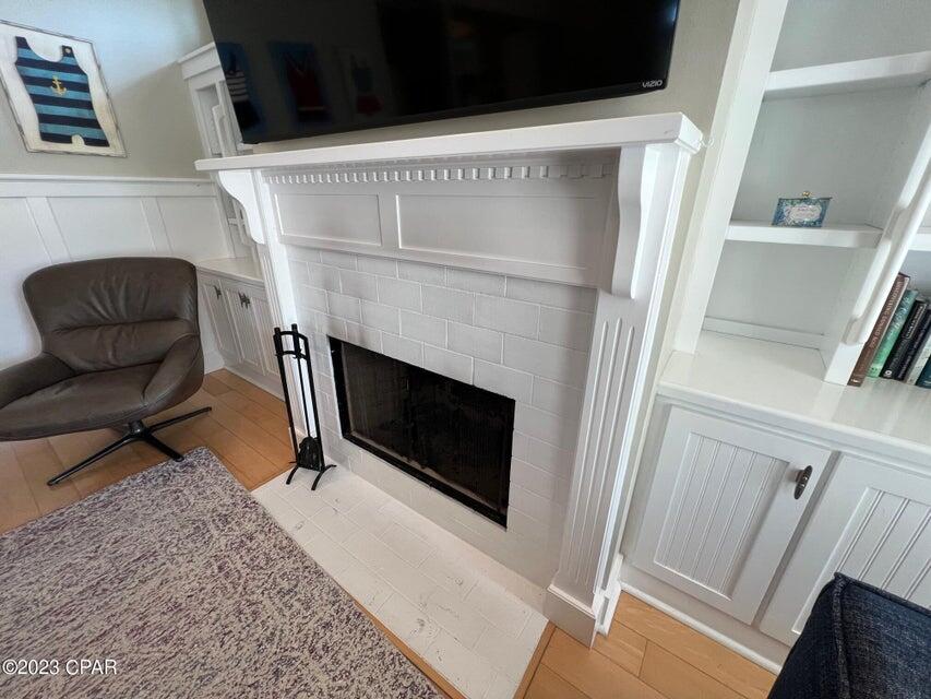 114 Parkshore Drive Panama City Beach, FL 32413 - Photo 7 of 86 a living room with a fireplace and a rug