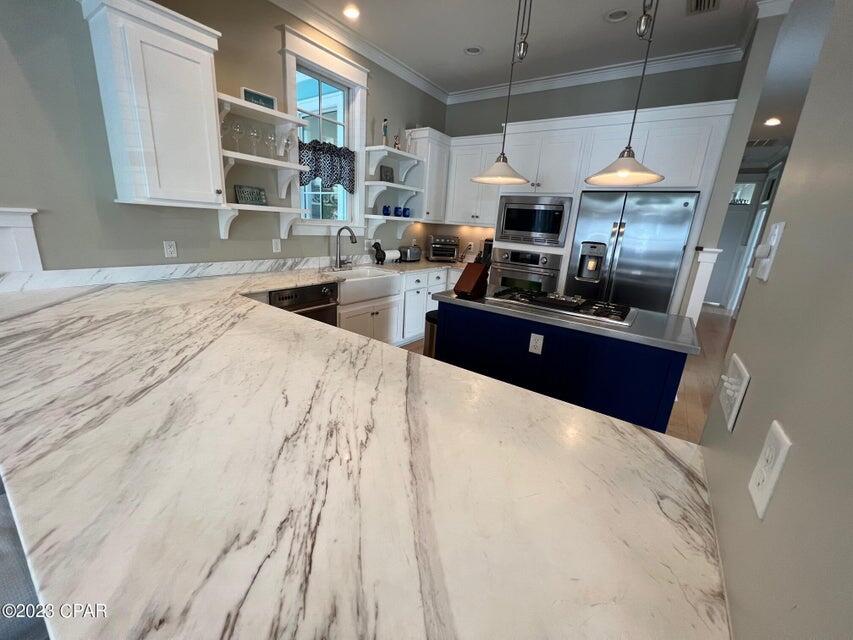 114 Parkshore Drive Panama City Beach, FL 32413 - Photo 9 of 86 a kitchen with stainless steel appliances kitchen island granite countertop a sink stove and cabinets