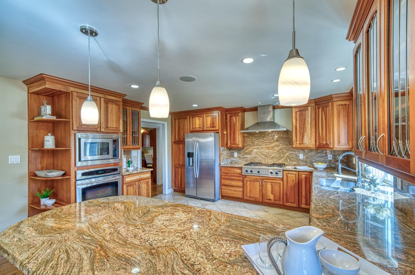 1174 Crandano Court Sunnyvale, CA 94087 - Photo 15 of 49 a large kitchen with kitchen island granite countertop wooden cabinets a granite counter tops and a sink