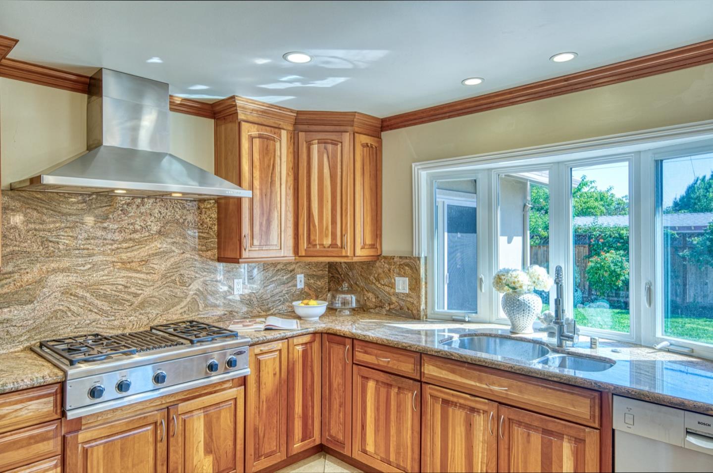 1174 Crandano Court Sunnyvale, CA 94087 - Photo 17 of 49 a kitchen with stainless steel appliances granite countertop a sink a stove and a wooden cabinets
