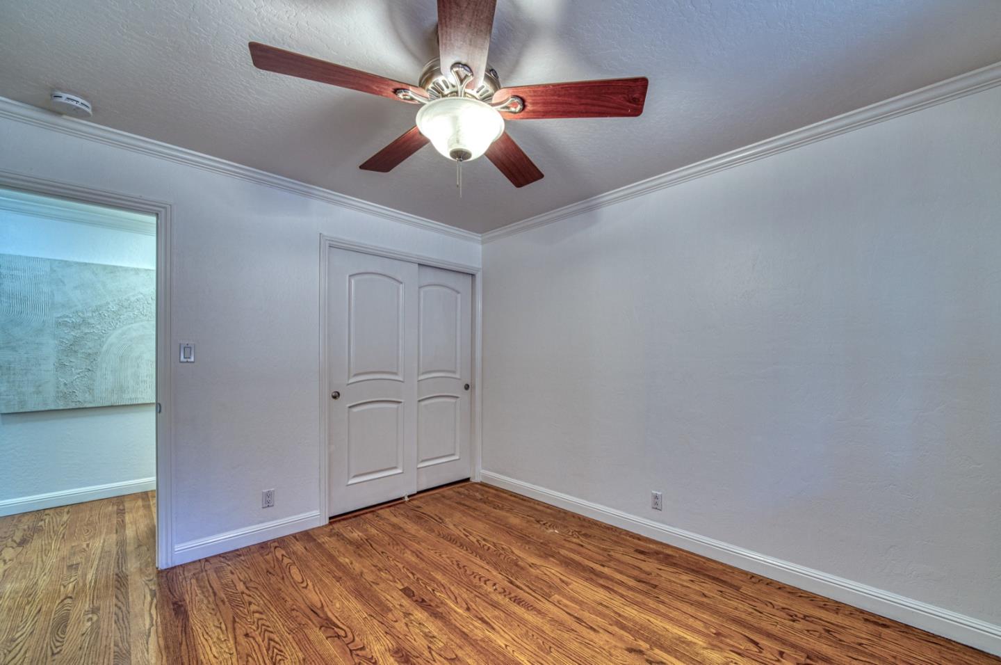 1174 Crandano Court Sunnyvale, CA 94087 - Photo 25 of 49 a view of a room with wooden floor and ceiling fan