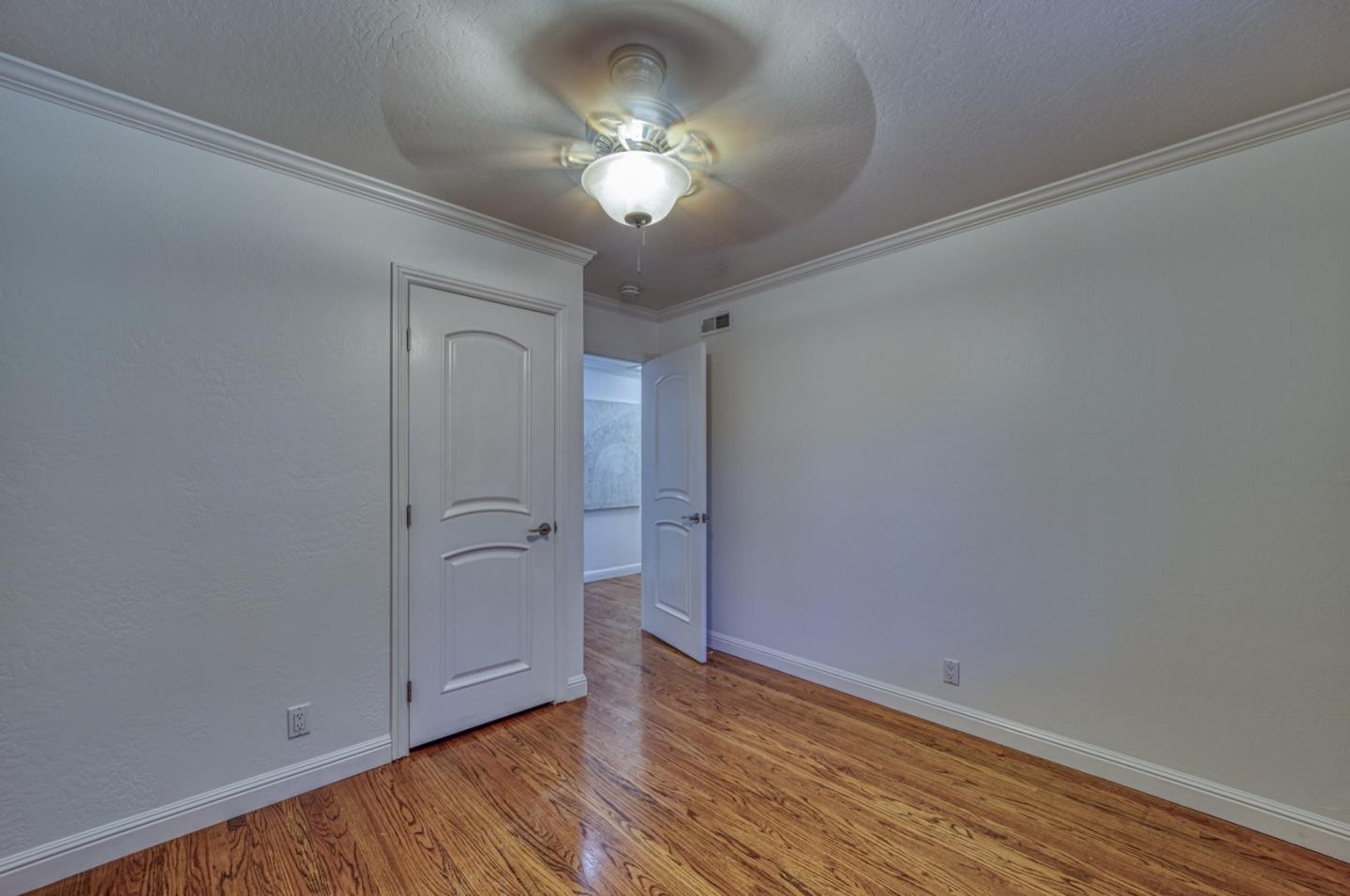 1174 Crandano Court Sunnyvale, CA 94087 - Photo 33 of 49 a view of a room with wooden floor and a ceiling fan