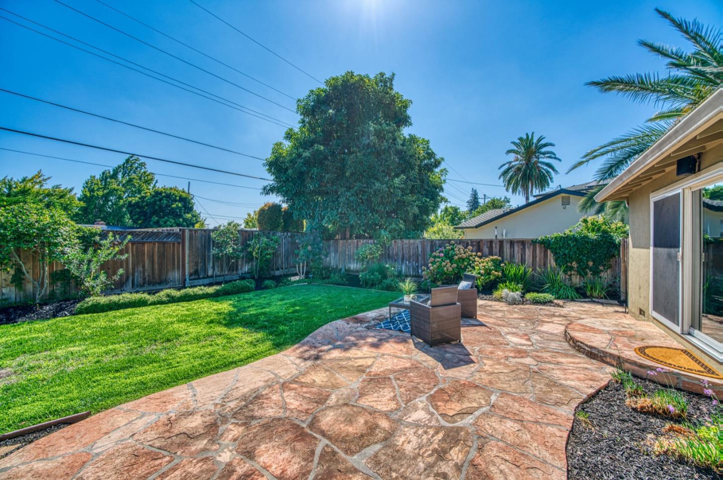 1174 Crandano Court Sunnyvale, CA 94087 - Photo 35 of 49 a view of a backyard with potted plants and wooden fence