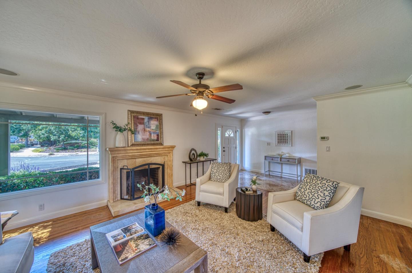 1174 Crandano Court Sunnyvale, CA 94087 - Photo 7 of 49 a living room with furniture a fireplace and a flat screen tv