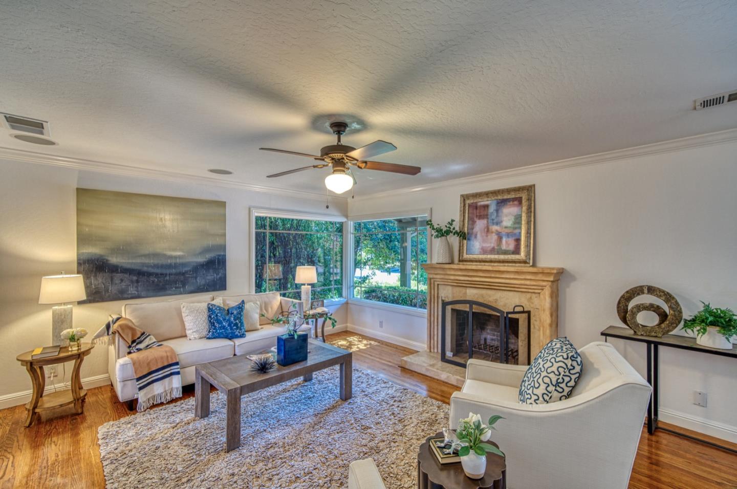 1174 Crandano Court Sunnyvale, CA 94087 - Photo 8 of 49 a living room with furniture a fireplace and a table