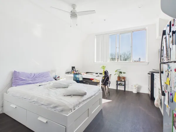 a bedroom with a bed and a table in it