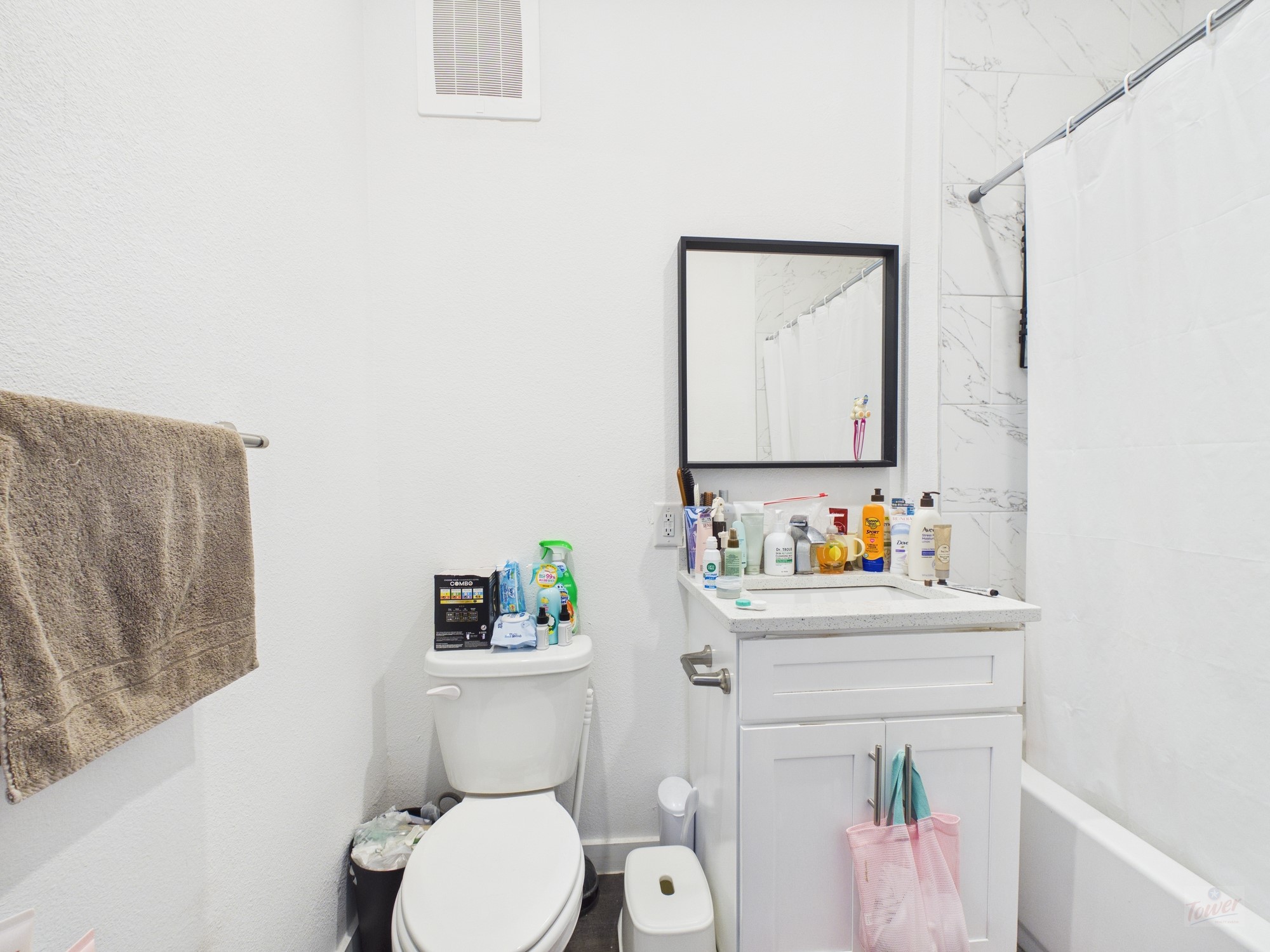 1010 West 26th Street, Unit 604 Austin, TX 78705 - Photo 7 of 7 a bathroom with a sink a toilet and a shower curtain