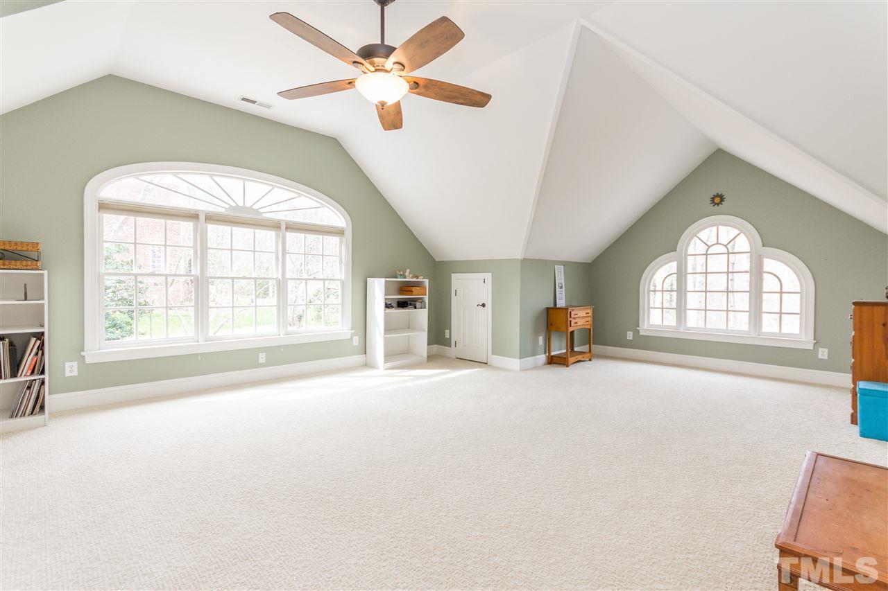10616 Cahill Road Raleigh, NC 27614 - Photo 12 of 24 an empty room with windows and ceiling fan