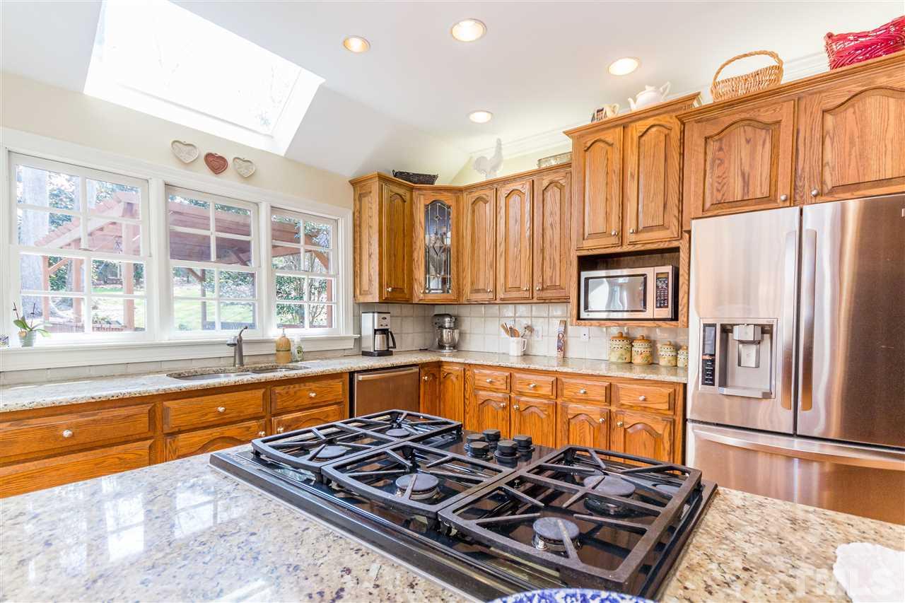 10616 Cahill Road Raleigh, NC 27614 - Photo 6 of 24 a large kitchen with stainless steel appliances granite countertop a stove and a sink