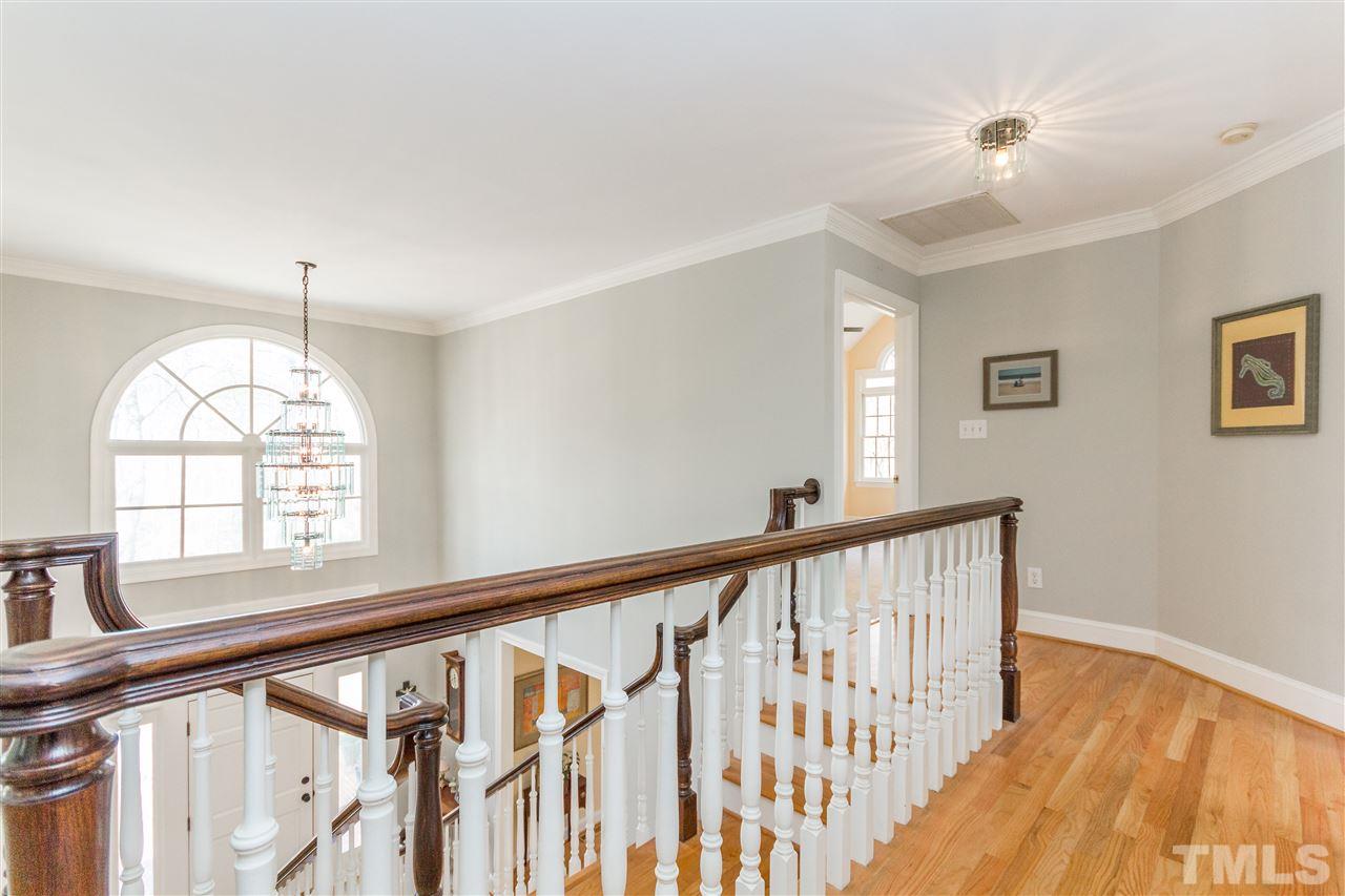 10616 Cahill Road Raleigh, NC 27614 - Photo 8 of 24 a view of staircase with wooden floor and a large window