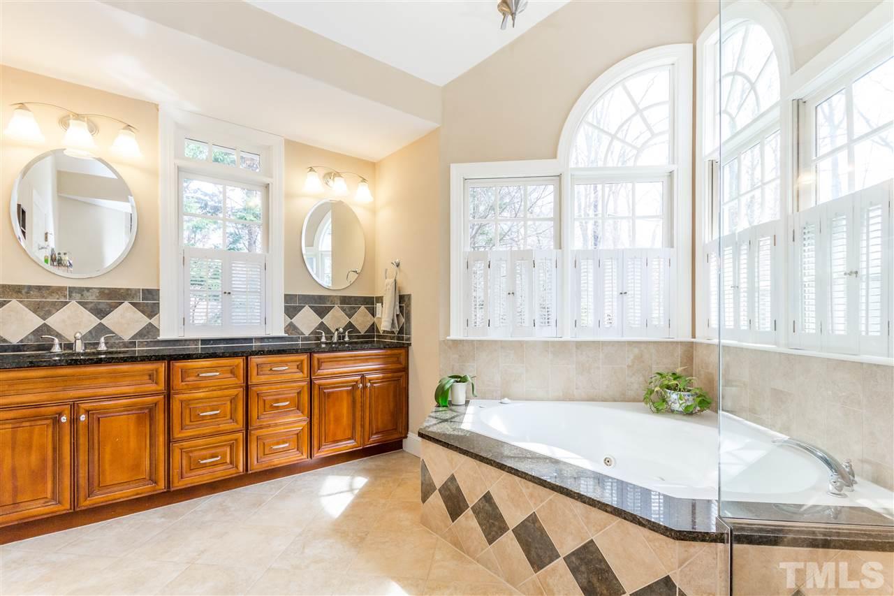 10616 Cahill Road Raleigh, NC 27614 - Photo 10 of 24 a spacious bathroom with a granite countertop double vanity sink a mirror and a bathtub