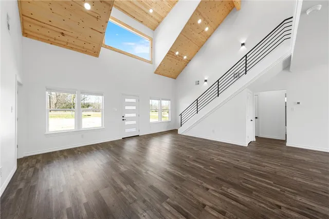 a view of a kitchen with kitchen island stainless steel appliances a refrigerator sink and a stove