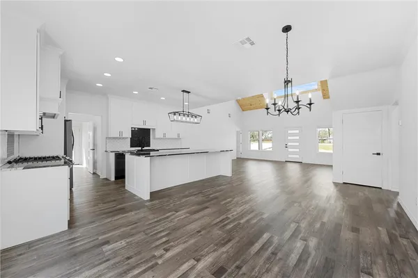 a view of a kitchen with stove and cabinets