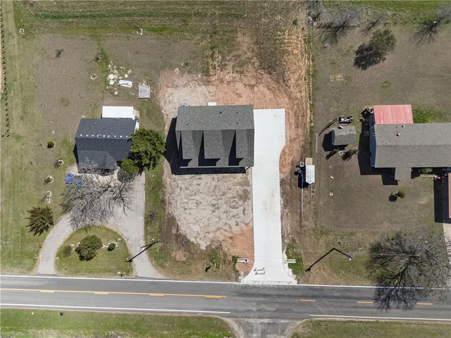 an aerial view of a house with garden space and outdoor seating