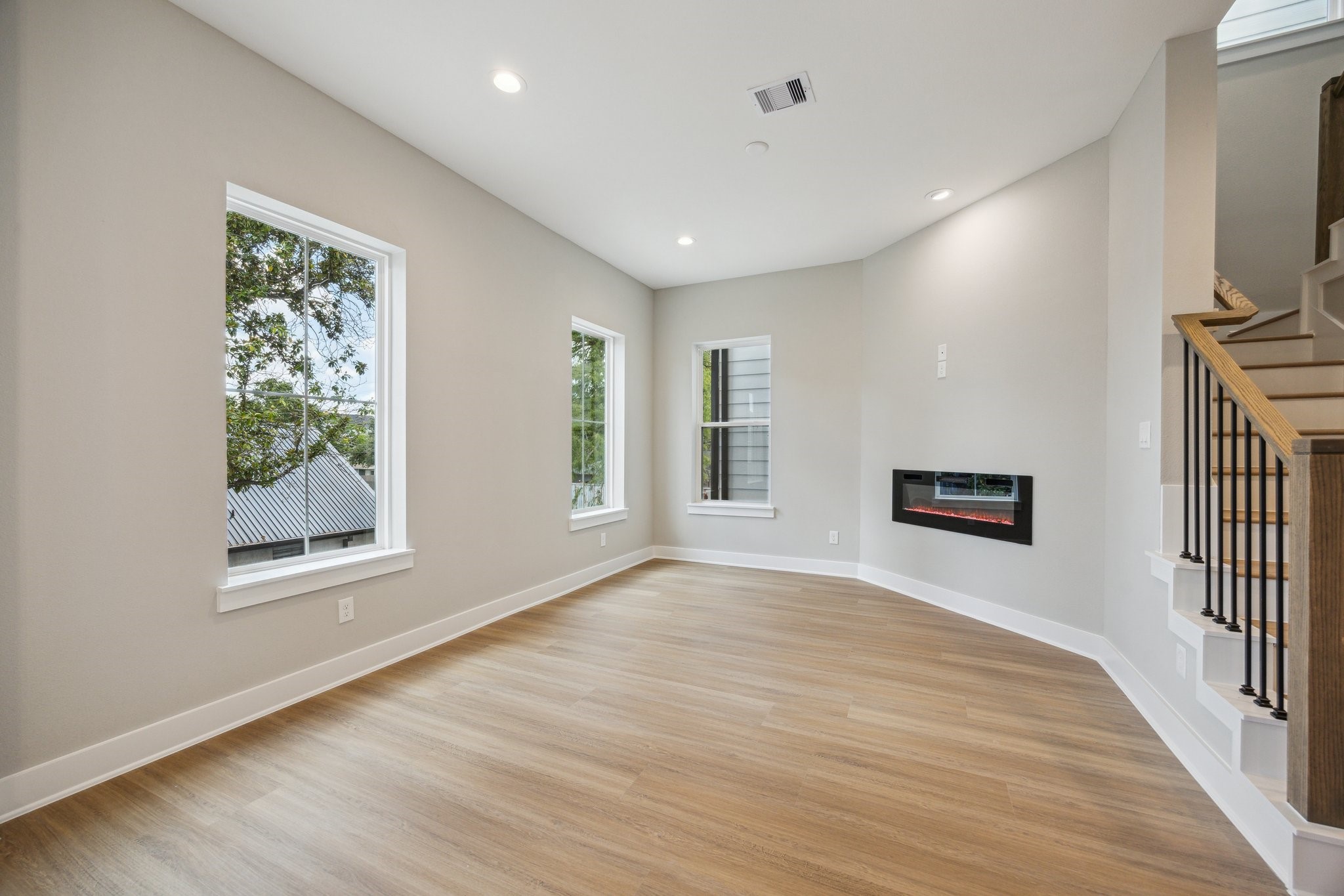 812 Thornton Road, Unit B Houston, TX 77018 - Photo 14 of 39 wooden floor in an empty room with a window