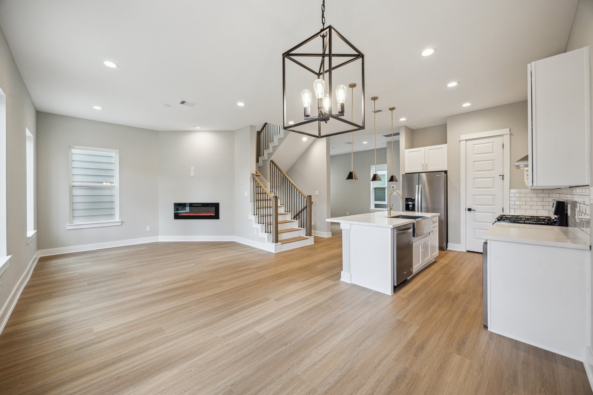 812 Thornton Road, Unit B Houston, TX 77018 - Photo 15 of 39 an open kitchen with wooden floor and stainless steel appliances