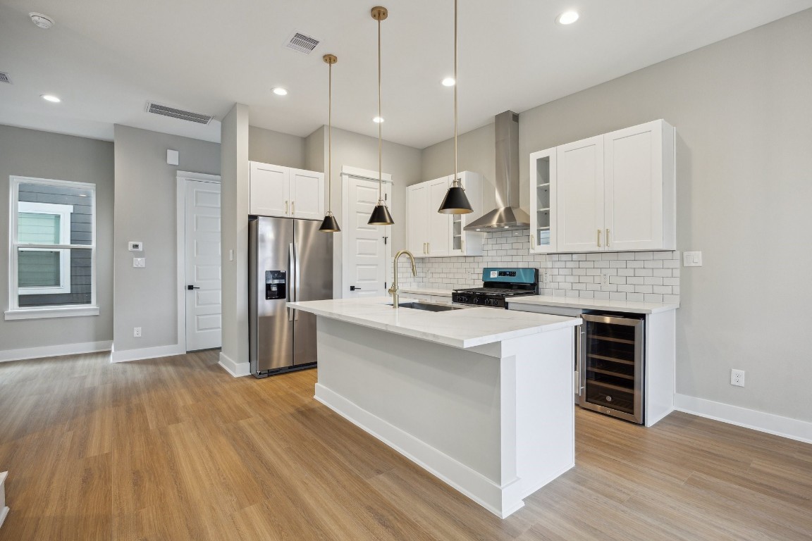 812 Thornton Road, Unit B Houston, TX 77018 - Photo 18 of 39 a kitchen with stainless steel appliances kitchen island wooden floors granite counter tops and a window