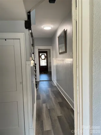 a view of a hallway with wooden floor