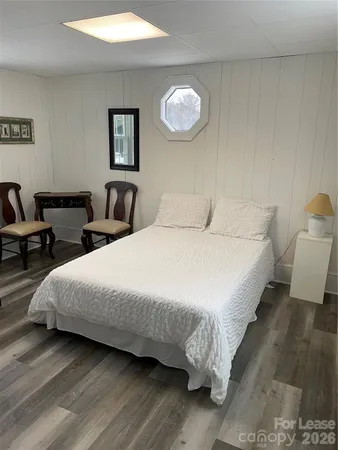 a bedroom with bed and a night stand