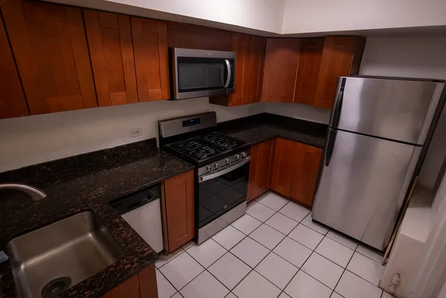 a kitchen with a refrigerator stove and microwave