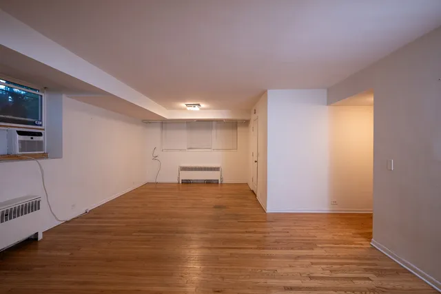 a view of a room with wooden floor