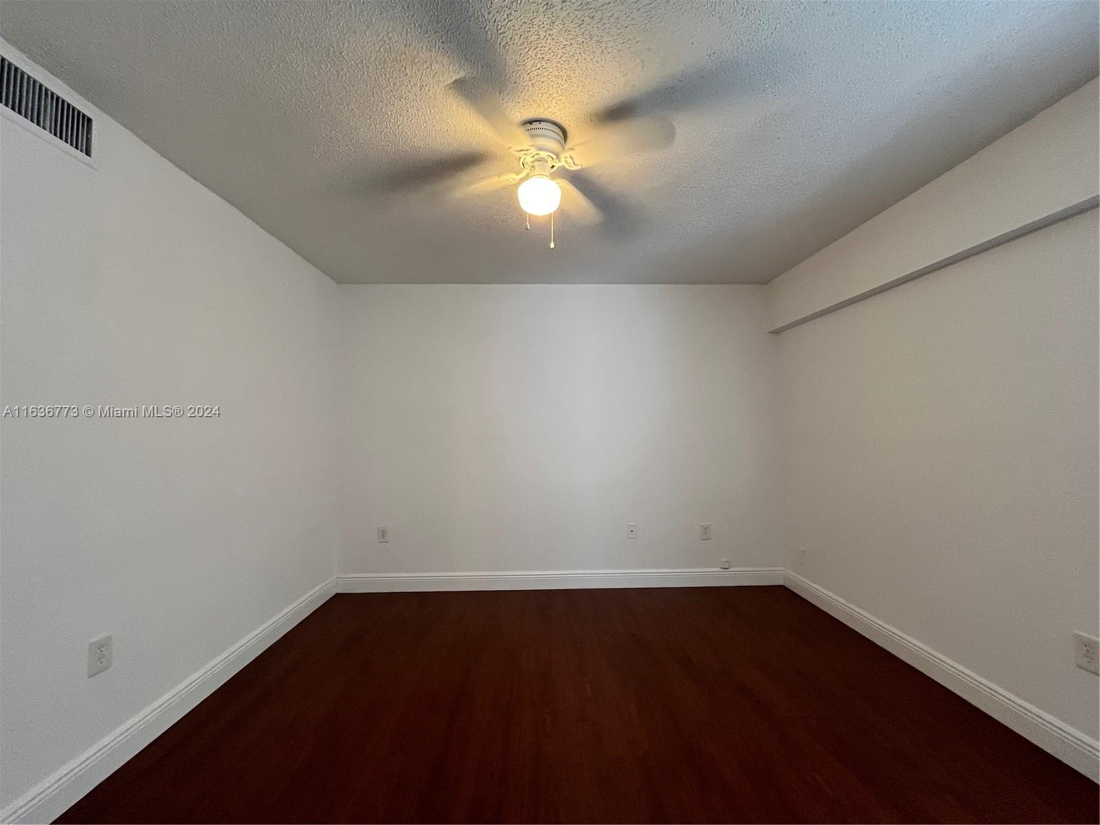 Hialeah Hialeah, FL 33012 - Photo 12 of 21 en empty room with wooden floor and fan