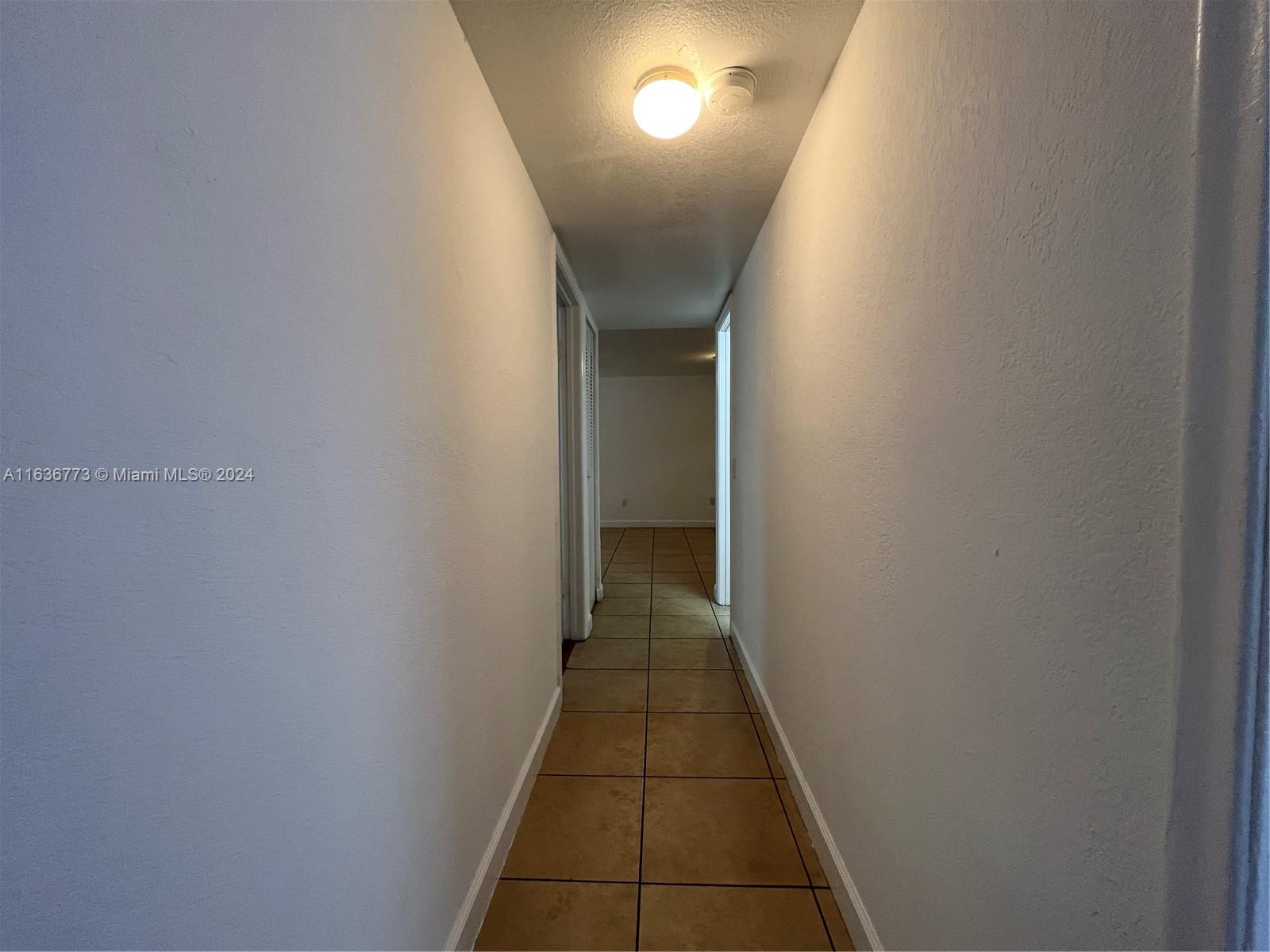 Hialeah Hialeah, FL 33012 - Photo 17 of 21 a view of a hallway with wooden floor