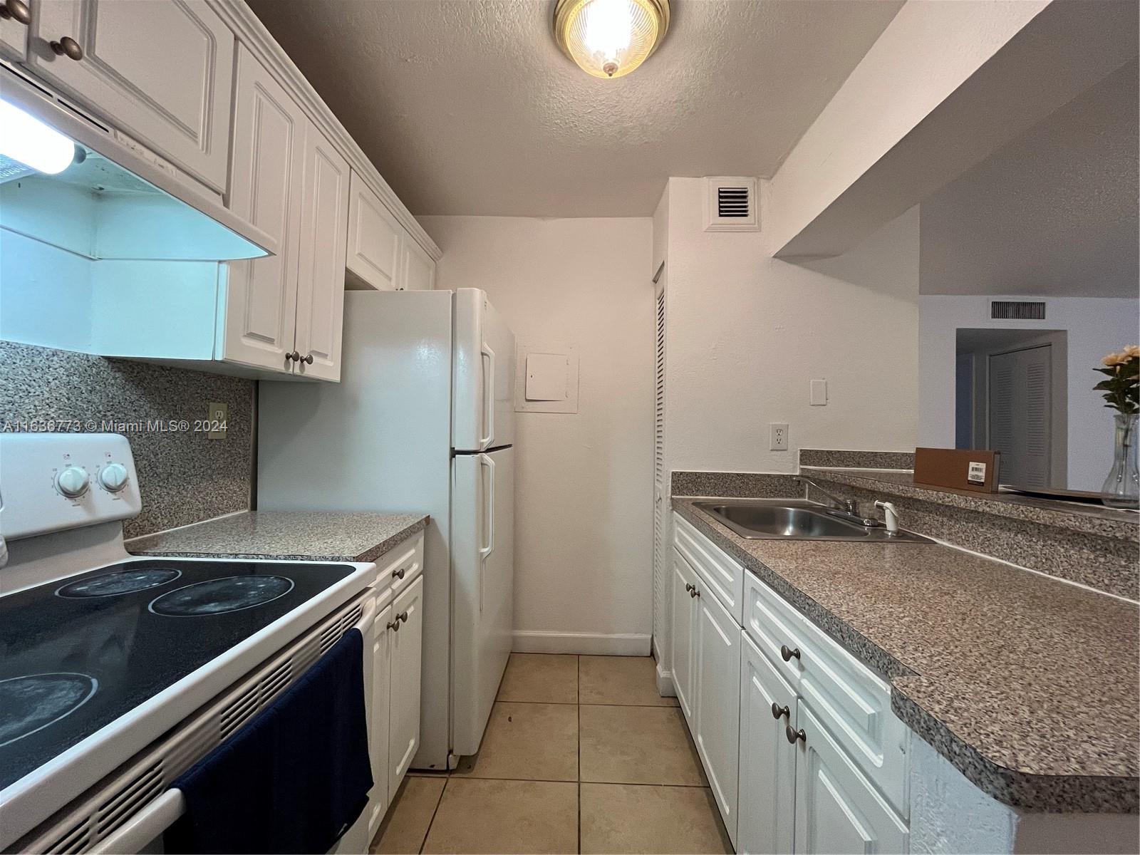Hialeah Hialeah, FL 33012 - Photo 2 of 21 a kitchen with stainless steel appliances granite countertop a sink stove and refrigerator
