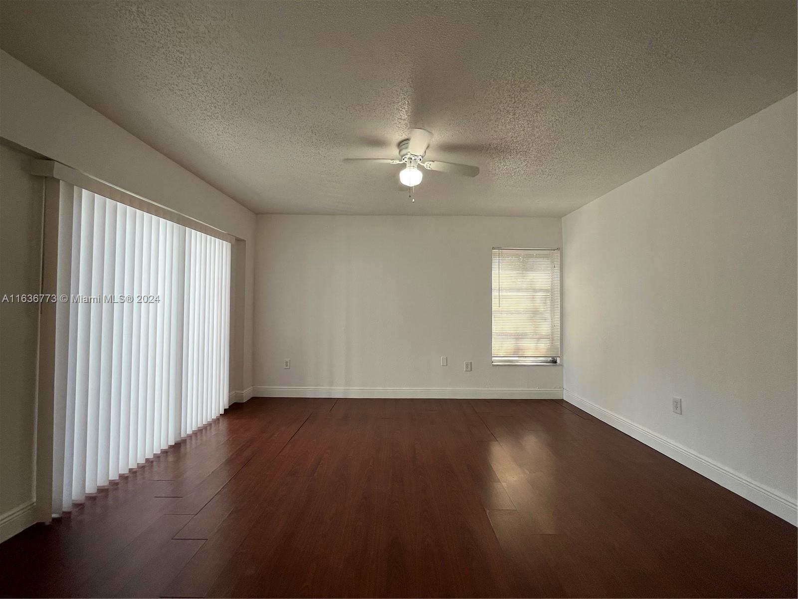 Hialeah Hialeah, FL 33012 - Photo 8 of 21 an empty room with wooden floor and windows