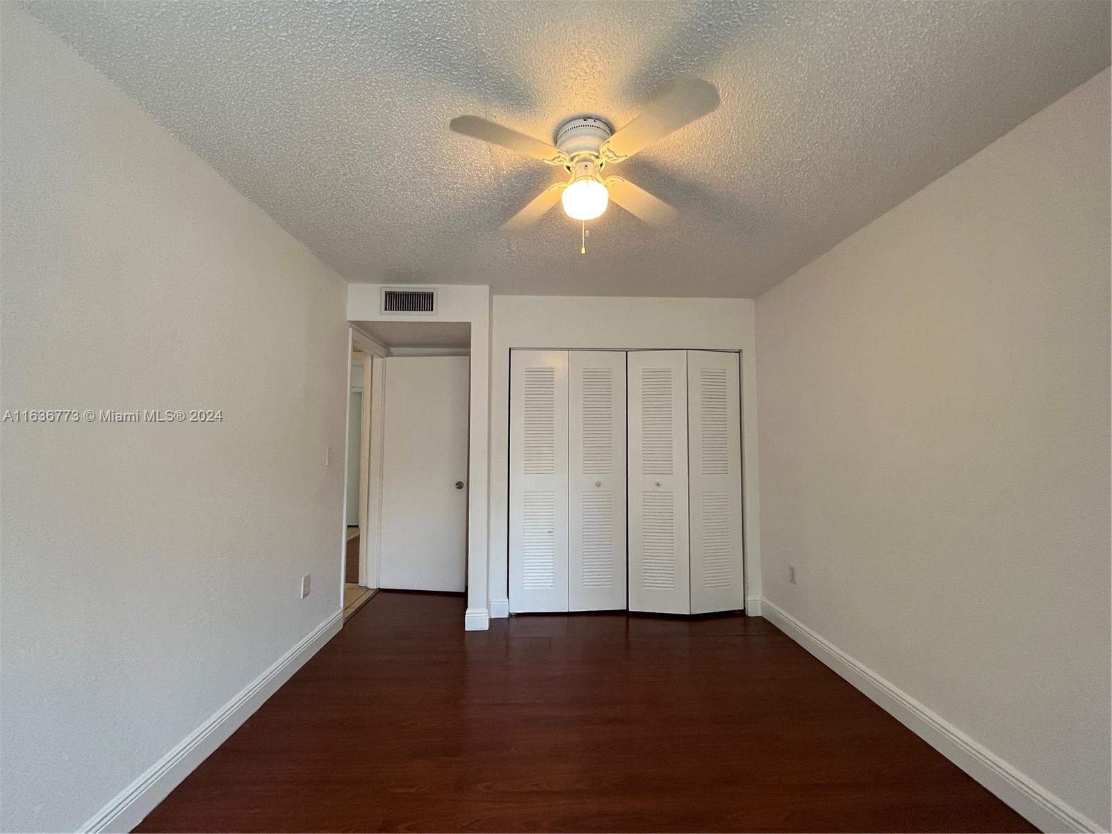 Hialeah Hialeah, FL 33012 - Photo 10 of 21 an empty room with wooden floor fan and windows