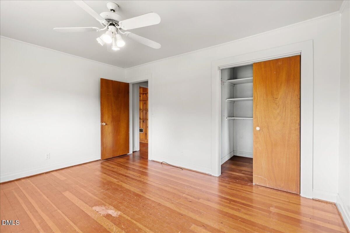 109 Little Ponderosa Road Macon, NC 27551 - Photo 18 of 32 an empty room with wooden floor and door