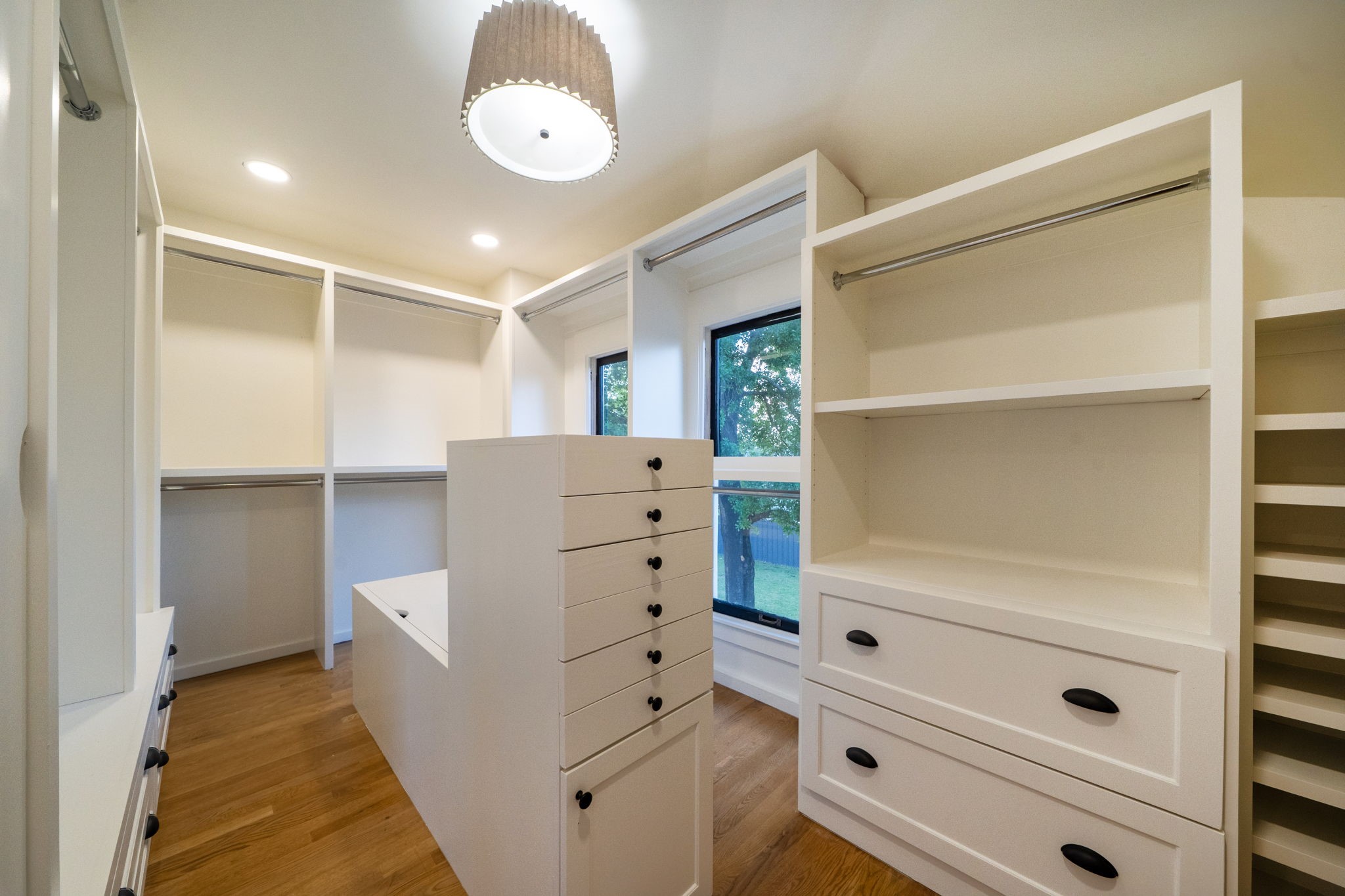 1109 Rutland Street Houston, TX 77008 - Photo 21 of 34 Freshly painted and thoughtfully upgraded, this primary closet now boasts a brand-new washer and dryer, perfectly tucked into the space for ultimate convenience. Sleek additional cabinetry enhances both storage and style, creating a seamless blend of functionality and elegance.