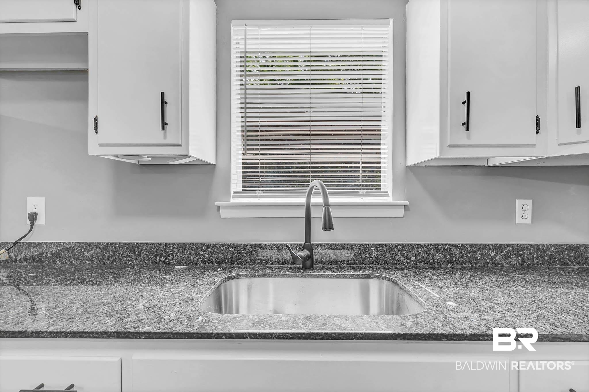 3304 Armond Drive Mobile, AL 36605 - Photo 20 of 62 Kitchen with white cabinetry and dark stone counters