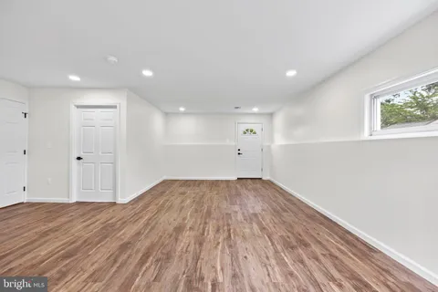 a view of a room with wooden floor and window