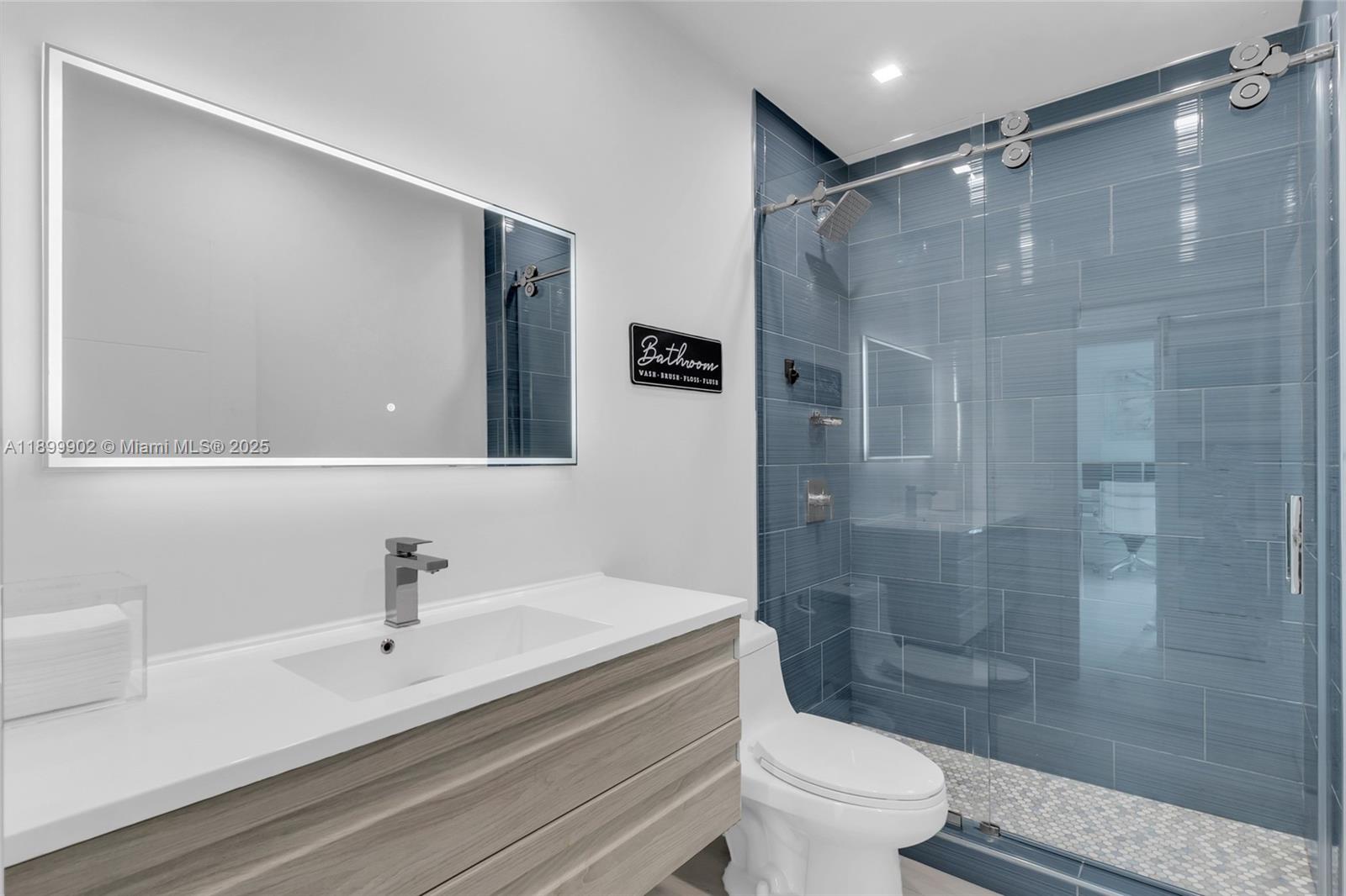 2525 Southwest 3rd Avenue, Unit 1002 Miami, FL 33129 - Photo 13 of 13 a bathroom with a sink a toilet and shower