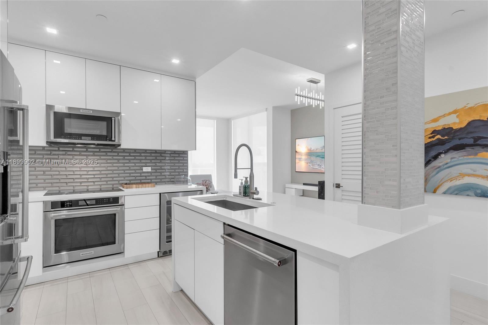 2525 Southwest 3rd Avenue, Unit 1002 Miami, FL 33129 - Photo 4 of 13 a kitchen with sink a microwave and stove