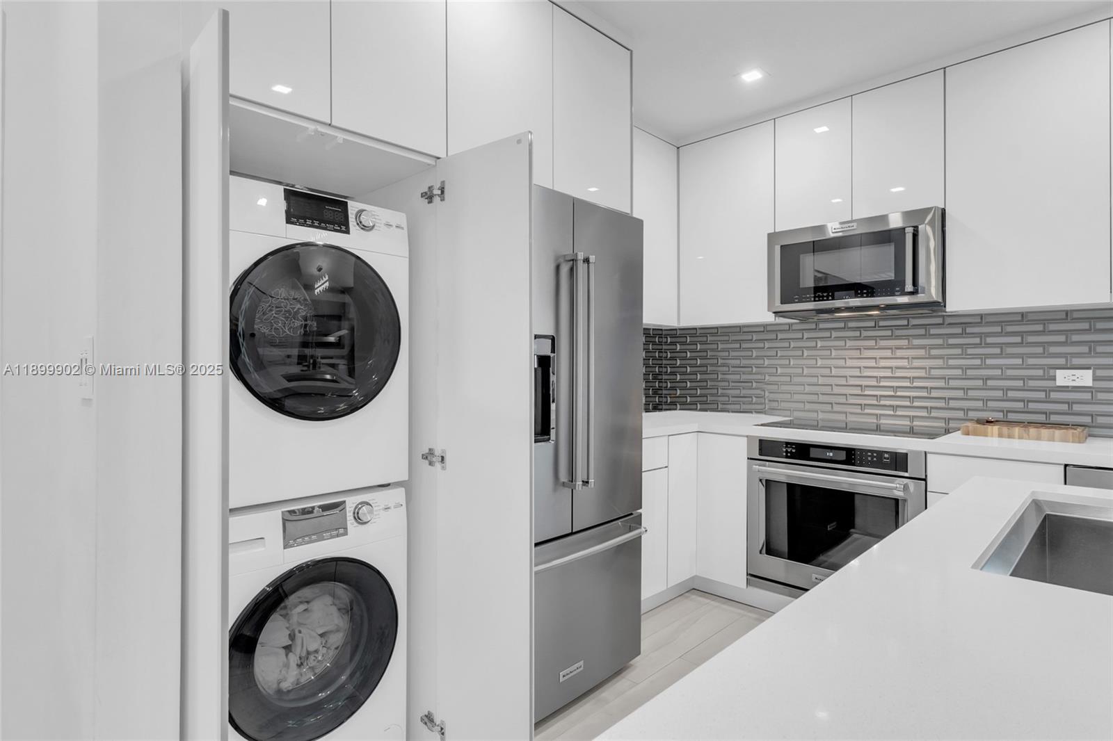 2525 Southwest 3rd Avenue, Unit 1002 Miami, FL 33129 - Photo 5 of 13 a kitchen with a washer and stainless steel appliances