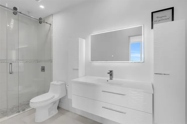 a bathroom with a sink toilet and shower