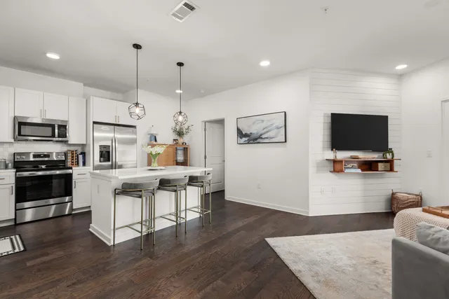 a view of kitchen with microwave stove top oven and cabinets