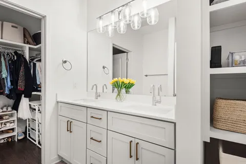 a bathroom with a sink vanity and a mirror