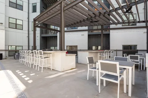 a view of a patio with a table and chairs