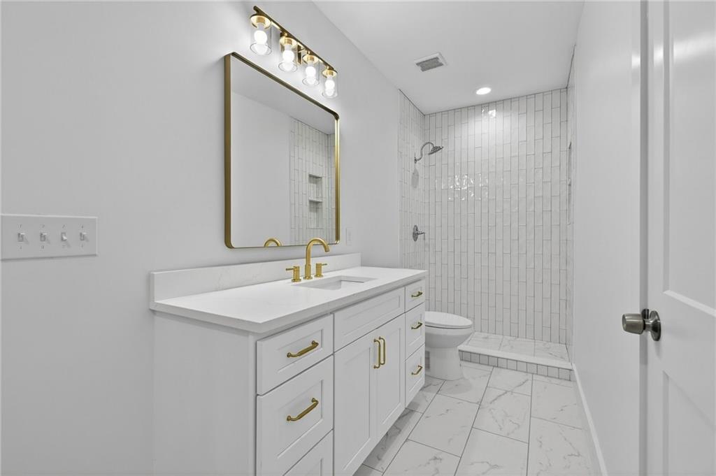 88 Carolyn Path Rockmart, GA 30153 - Photo 54 of 73 a bathroom with a toilet sink and mirror