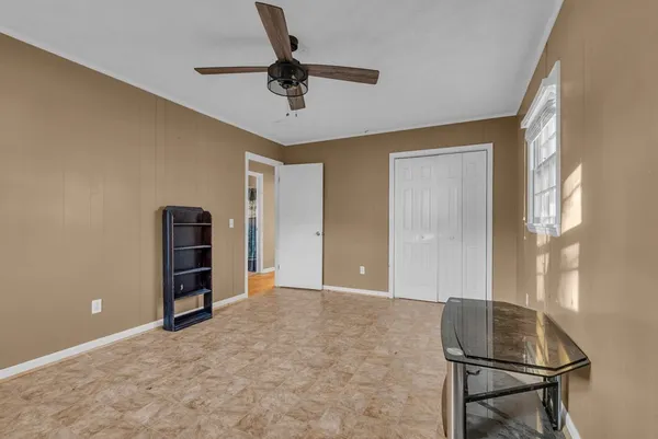 a view of a livingroom with furniture and a ceiling fan