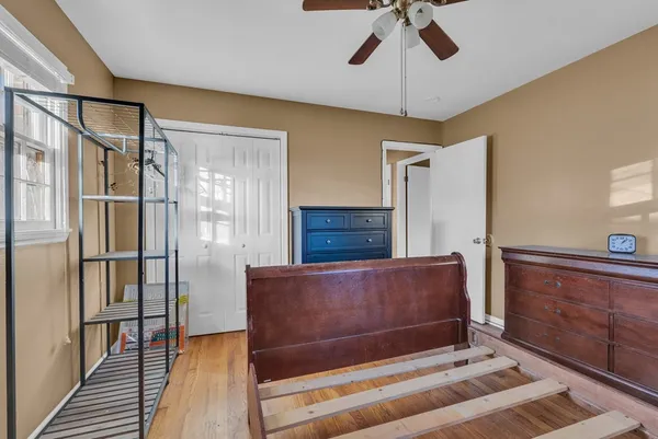 a living room with a couch and a dresser with wooden floor