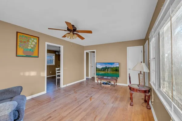 a living room with furniture and a wooden floor