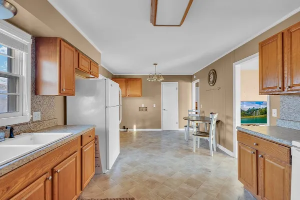 a kitchen with stainless steel appliances granite countertop a refrigerator and a stove top oven